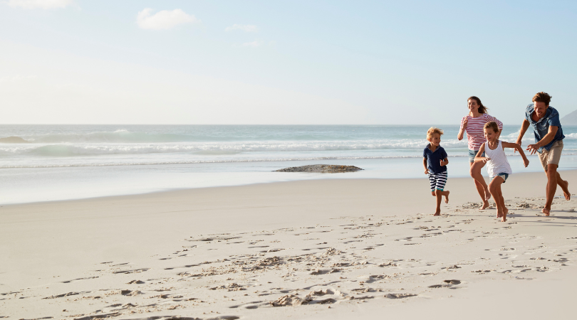 Family running on beach