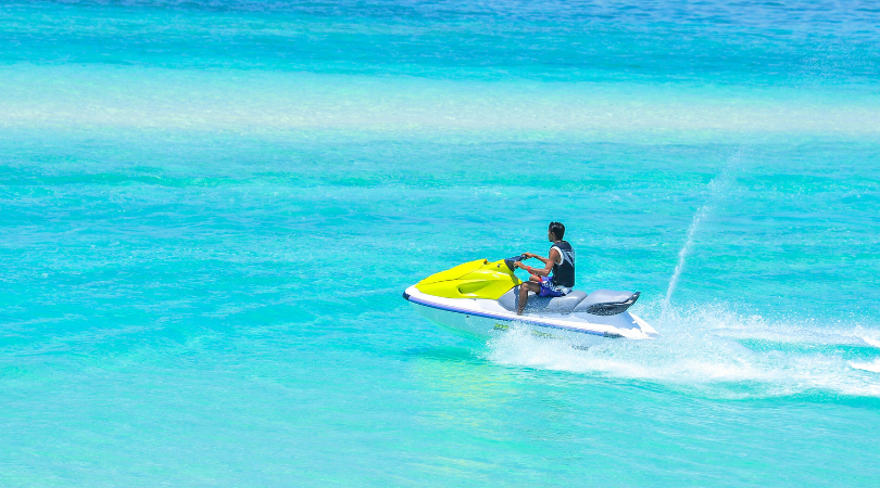 teen jet skiing in ocean
